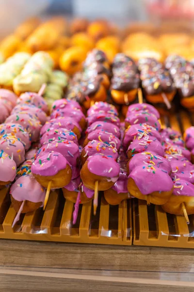 Assorted colorful glazed donut stick in confectionery store for sale — Stock Photo, Image