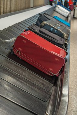 Suitcases on luggage conveyor belt at arrival department in airport