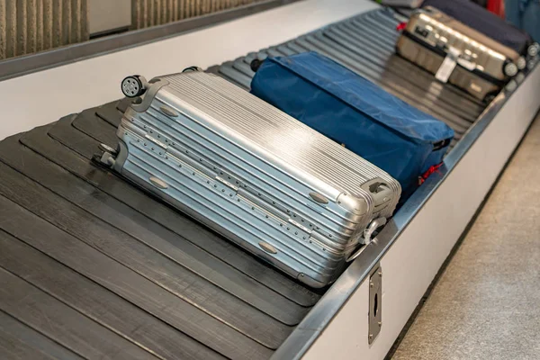 Bagagli passeggeri su nastro trasportatore al terminal di arrivo in aeroporto — Foto Stock