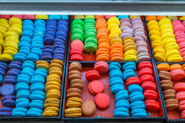 Multicolored and sweet macaroon cakes in French pastry shop