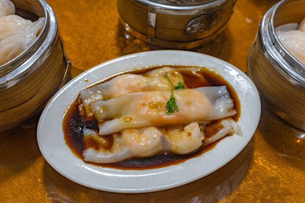 Hong Kong steamed shrimp rice rolls served with soy sauce