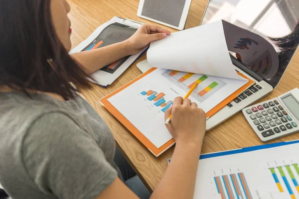 Rear view of female business employee analyzing sales report data — 스톡 사진