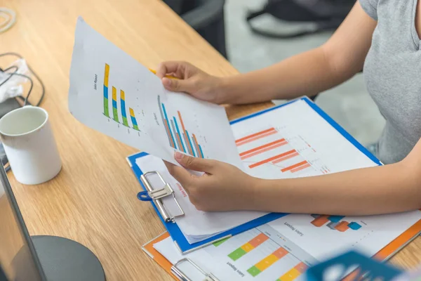 Asian manager checking financial sales reports in her business office — 스톡 사진