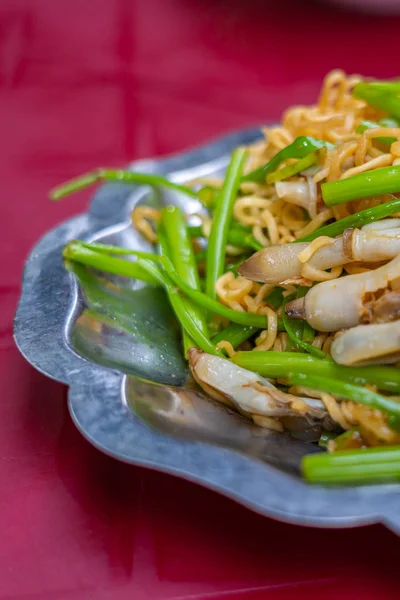Closeup shot of stir-fried snail noodles and water spinach — Stock Photo, Image