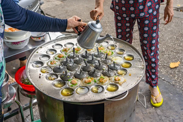 Street food hawker making Vietnamese mini shrimp pancake- Banh Khot — Stock Photo, Image