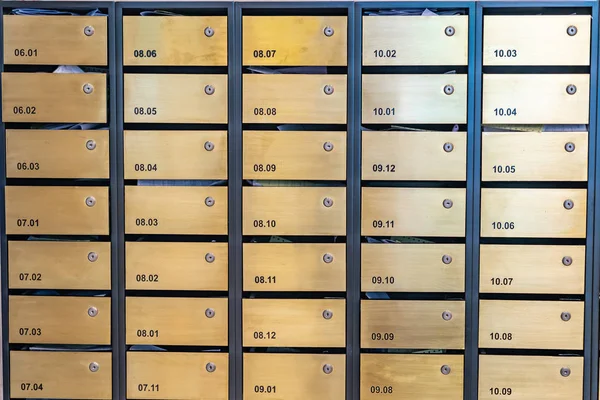 Metallic letter mailboxes at postal room in condominium building