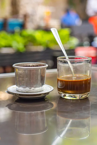 Vietnam styled brewed coffee and dripping filter on table