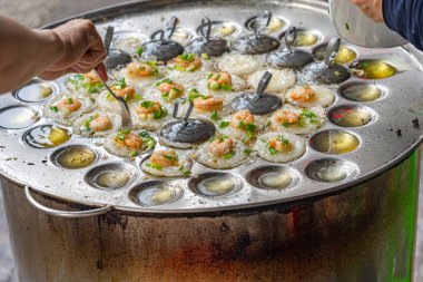 Hawker küçük kızarmış karidesli krep yapıyor- Banh Khot Vietnam mutfağı