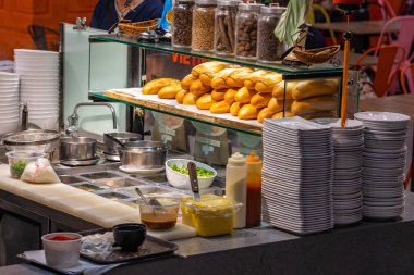 Vietnamese banh mi food stands kitchen in foodcourt clipart