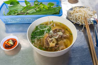 Famous Vietnamese cuisine - Pho beef noodle served with vegetable