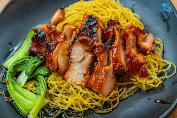 Plate of Chinese styled honey grilled pork belly noodles 