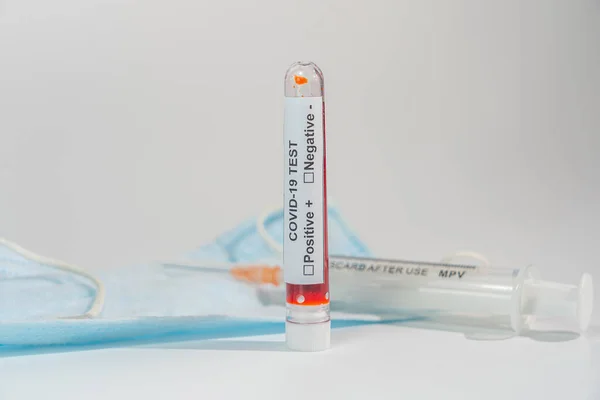Blutprobe von COVID-19 und Spritze auf weißem Hintergrund — Stockfoto