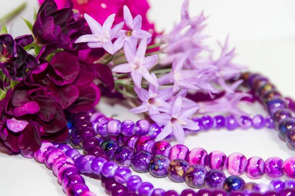 feminine and romantic pearls and flowers in violet tone