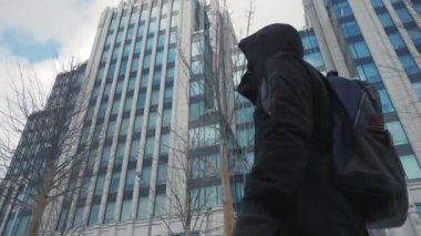 Baş ve sırt çantası şehir street yürüyüş kaputa ile siyah ceketli adamı