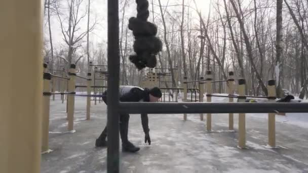 Ejercicio de entrenamiento de fitness con expansor deportivo al aire libre en el parque de invierno — Vídeos de Stock