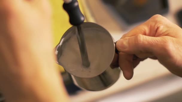 Barista preparing milk for latte coffee close up. Man making coffee cappuccino — Stock Video