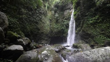 Amazing view of a tropical rainforest waterfall in the Philippines with few tourist.