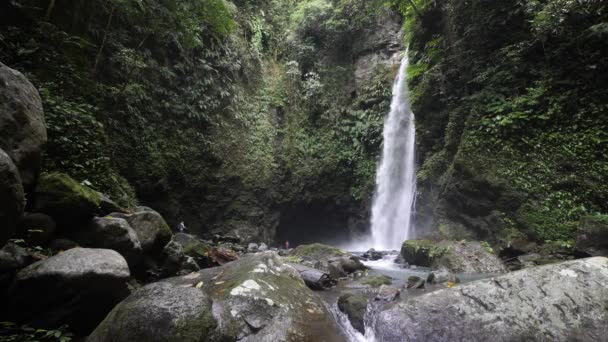 Amazing view of a tropical rainforest waterfall in the Philippines with few tourist. — Stock video