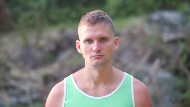 Young masculine man portrait showing a serious and a smiling face. — Stock video