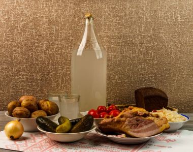 Ukrayna Ulusal içecek ve aperatif. Büyük şişe ve bardak kaçak içki eski ahşap tablo 