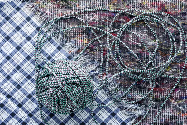 Ball of colored rope on a cloth background