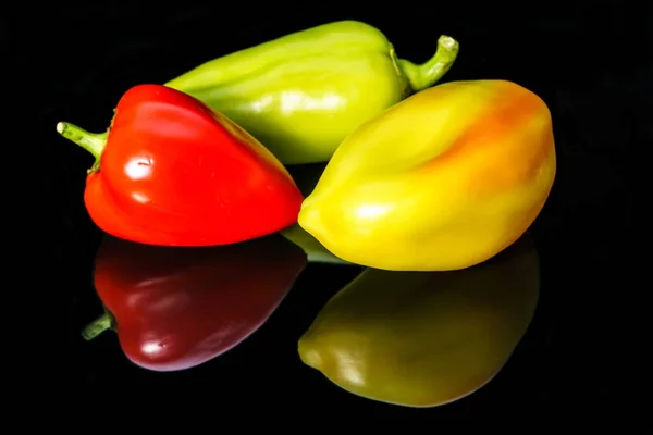 Sweet colorful peppers isolated on a black background — Stock Photo, Image