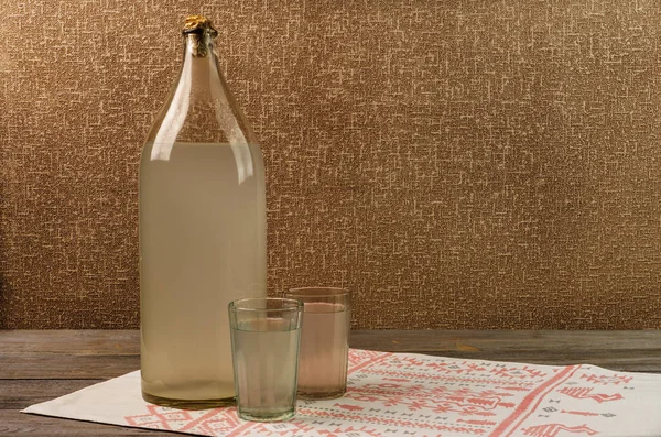 Ukrainian national drink. The big bottle of moonshine. Old bottle and two glass with russian vodka. — Stock Photo, Image