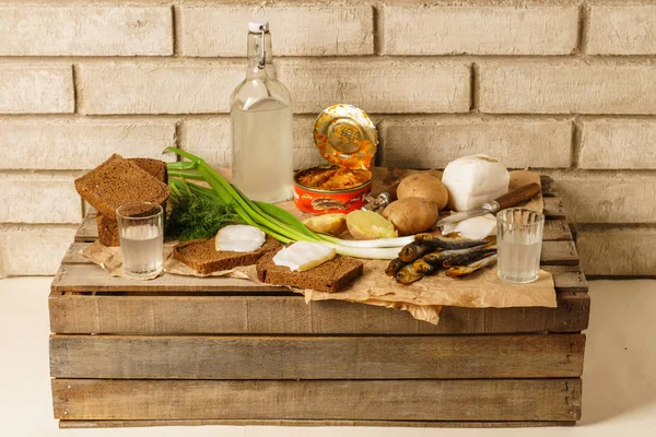 Traditional Ukrainian and Russian snacks outdoor. Food with alcohol. Russian vodka, canned gobies in tomato sauce, smoked fish, sandwiches with bacon and onions. — Stock Image Traditional Ukrainian and Russian snacks outdoor. Food with alcohol. Russian vodka, canned gobies in tomato sauce, smoked fish, sandwiches with bacon and onions. Royalty Free Stock Photos