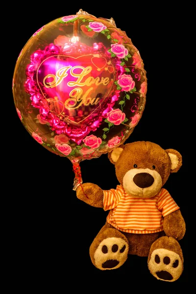 Teddy Bear holding red heart-shaped balloon. Valentine bear with — Stock Photo, Image