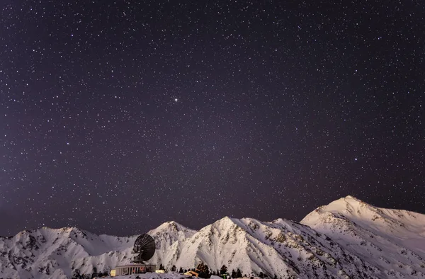 High in the mountains stars in the sky with a telescope