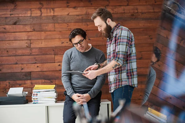 Male designers pointing at digital tablet — Stock Photo, Image