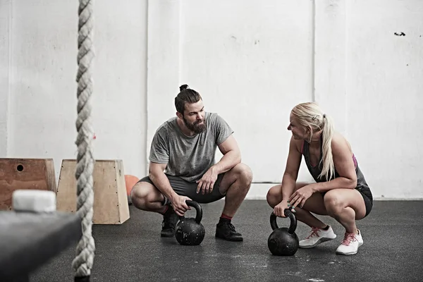 Casal com kettlebells no ginásio — Fotografia de Stock