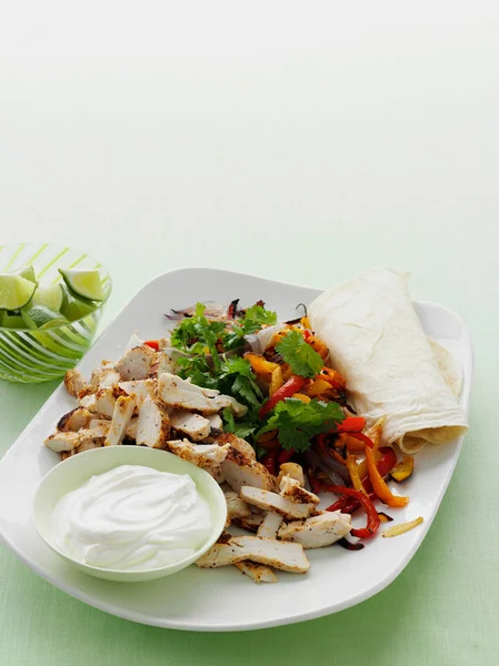 Plate of spicy chicken burrito — Stock Photo, Image