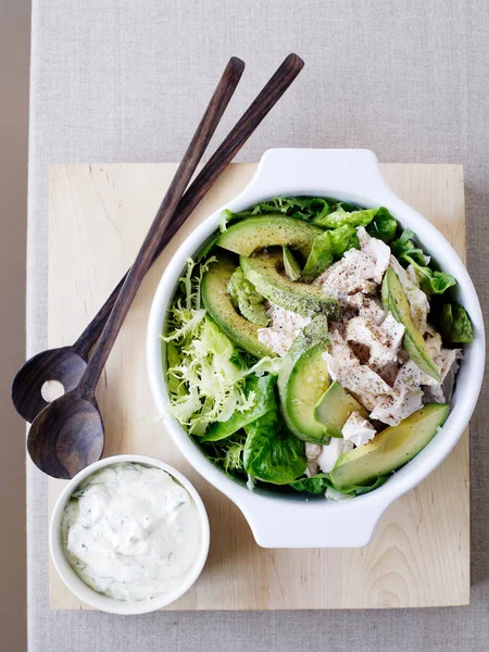 Chicken and avocado salad and sauce in bowls — Stock Photo, Image