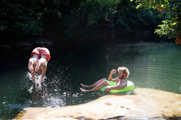 Two men playing in river — Stock Photo, Image