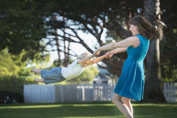 Mother Swinging Son Outdoors — Stock Photo, Image