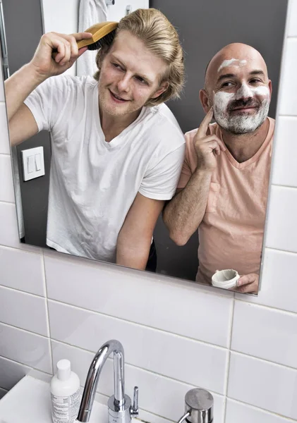 Bathroom Mirror Image Male Couple Shaving Brushing Hair — Stock Photo, Image