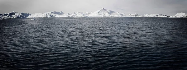 Porlande sjön i snöiga landskap — Stockfoto