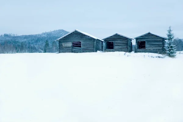 Casas de madera en campo nevado —  Fotos de Stock
