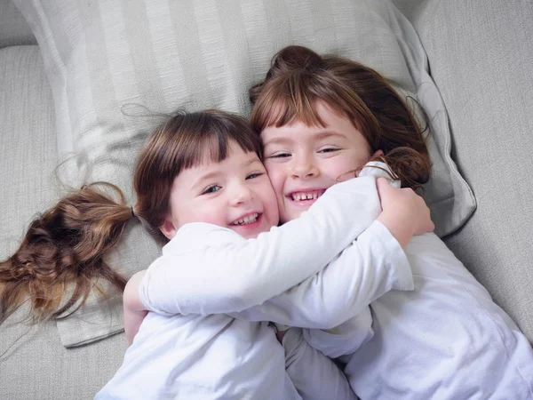 Girls Hugging Sofa Together — Stock Photo, Image