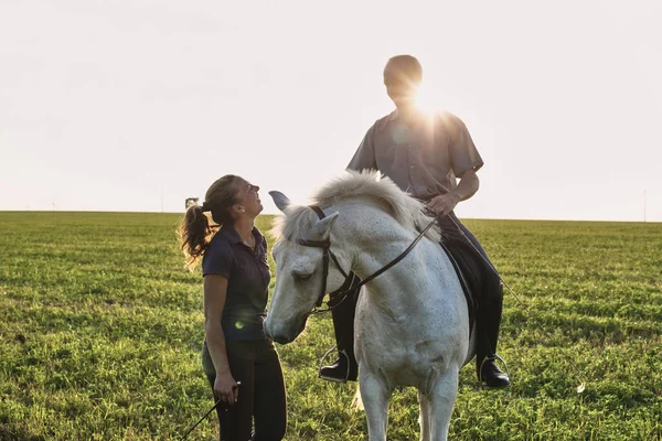 Woman Chatting Man Riding Grey Horse Field — Stock Photo, Image