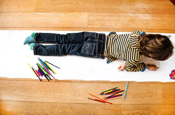 Overhead View Boy Lying Top Drawing Long Paper — Stock Photo, Image