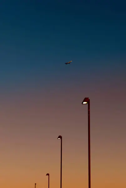 Airplane over street lights — Stock Photo, Image