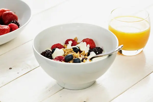 Breakfast with berries and juice glass — Stock Photo, Image