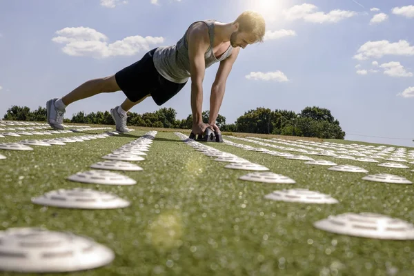 Young Man Doing Push Ups Hand Weights Sports Field — Stock Photo, Image