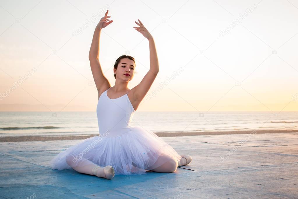 Ballerina posing at sunset
