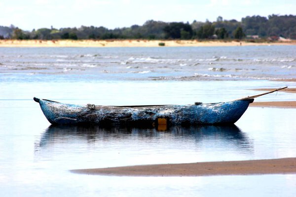 Dugout boat in the shallow water on the banks of Lake Malawi.