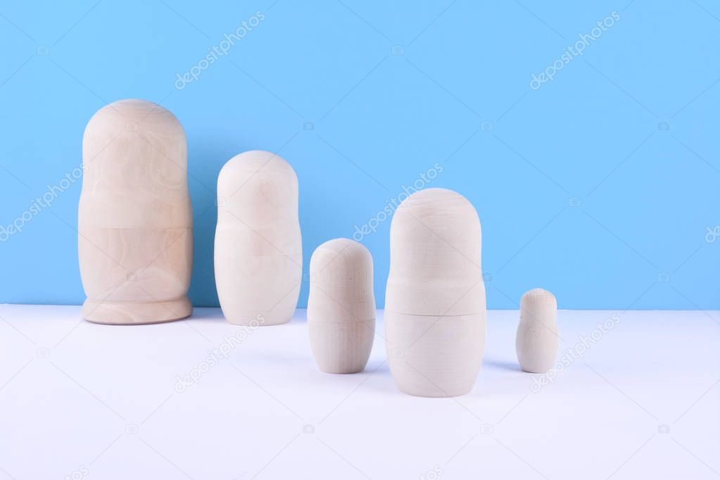 Set of russian dolls on blue background.