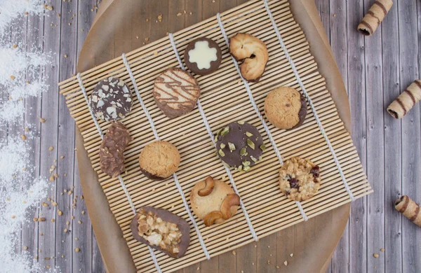 Dark vintage background with various homemade cookies. — Stock Photo, Image