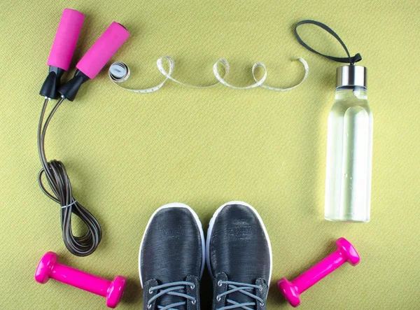 Flat lay shot of sneakers, earphones, phone.